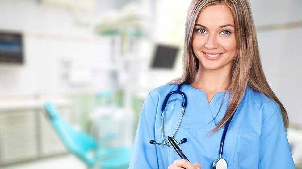 Young nurse taking notes in hospital room